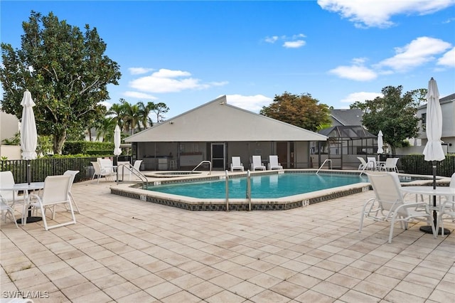 view of pool featuring a sunroom and a patio