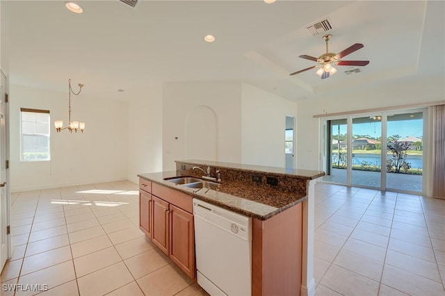 kitchen featuring white dishwasher, plenty of natural light, sink, and decorative light fixtures