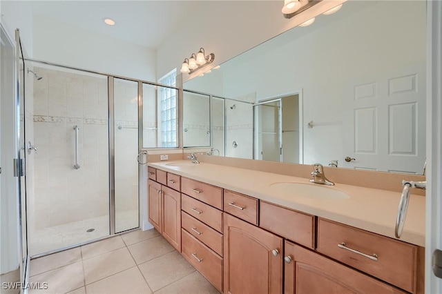 bathroom featuring tile patterned floors, a shower with door, and vanity