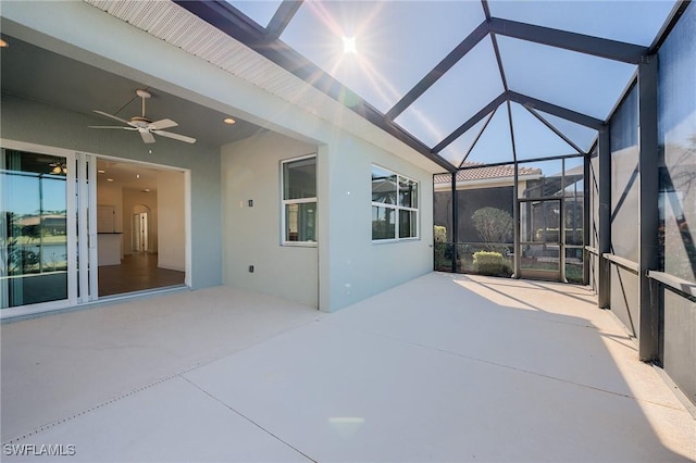 view of patio featuring ceiling fan and a lanai