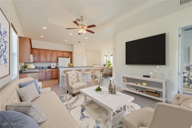 living room featuring light tile patterned floors and ceiling fan