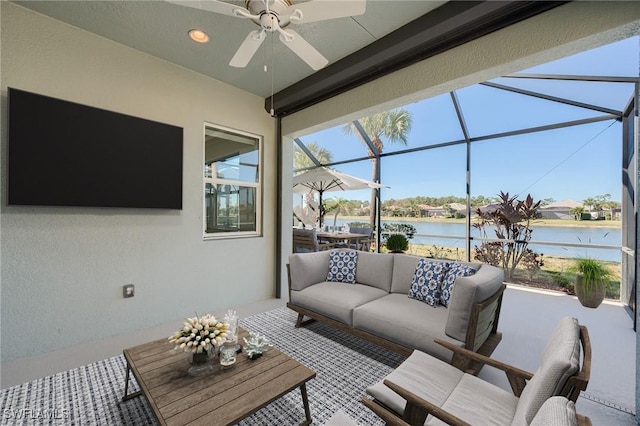 view of patio / terrace with a lanai, outdoor lounge area, ceiling fan, and a water view