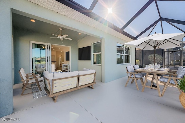 view of patio / terrace featuring ceiling fan and a lanai