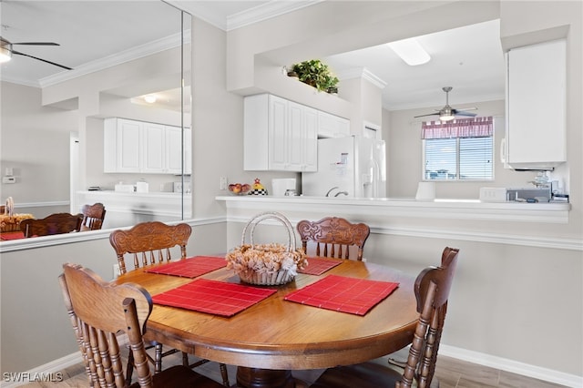 dining area featuring crown molding, ceiling fan, and baseboards