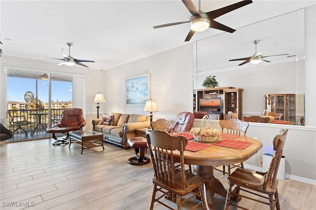 dining room with crown molding and light hardwood / wood-style flooring