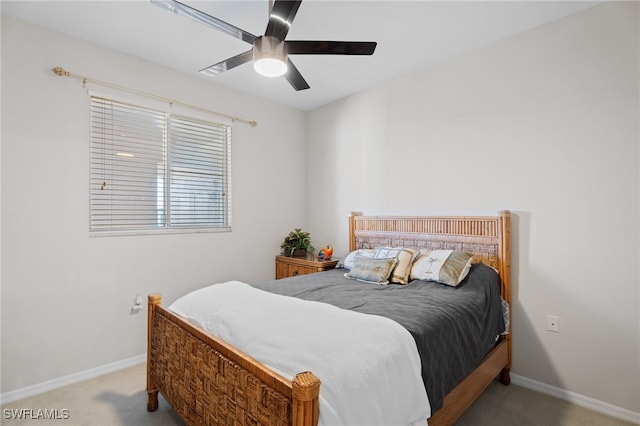 bedroom with ceiling fan, baseboards, and carpet