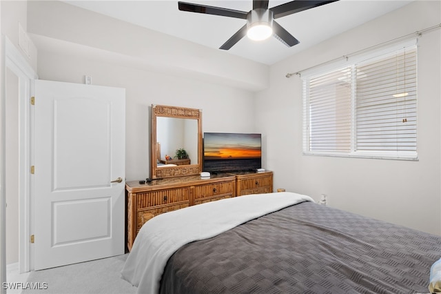 bedroom with ceiling fan and light carpet