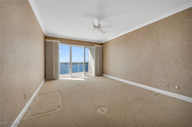 empty room featuring baseboards, ornamental molding, carpet flooring, and a textured wall