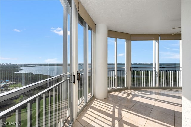 unfurnished sunroom with a water view