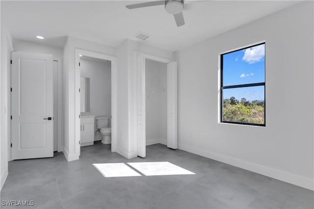 unfurnished bedroom with ceiling fan and ensuite bathroom