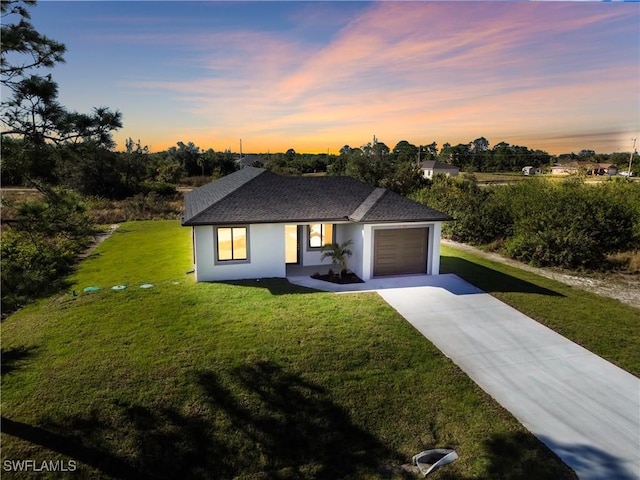 view of front of property with a lawn and a garage