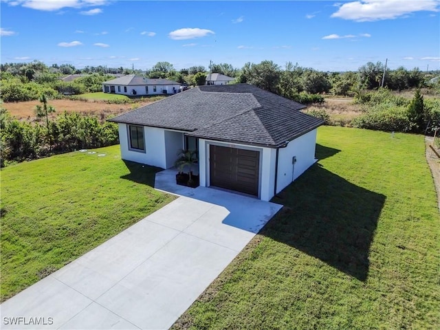 312 Progress Ave, Lehigh Acres, FL 33974 - view of front of home with a front yard, an attached garage, concrete driveway, and roof with shingles