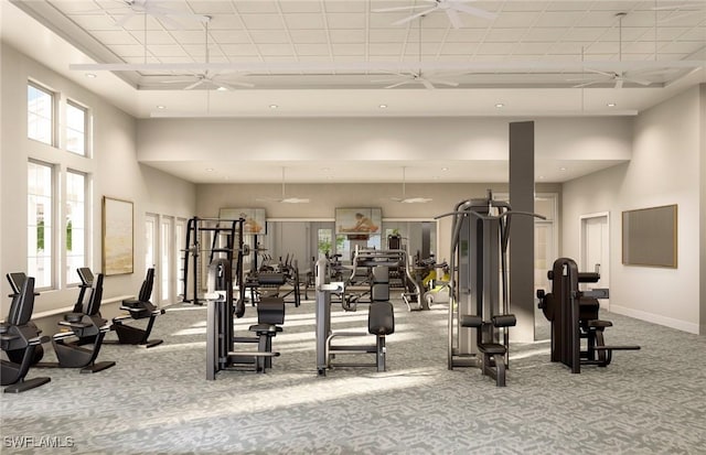 workout area featuring a high ceiling, light colored carpet, and ceiling fan