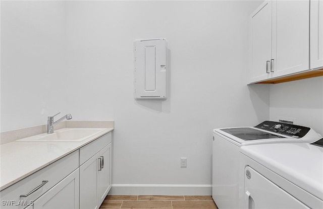 clothes washing area featuring cabinets, independent washer and dryer, and sink