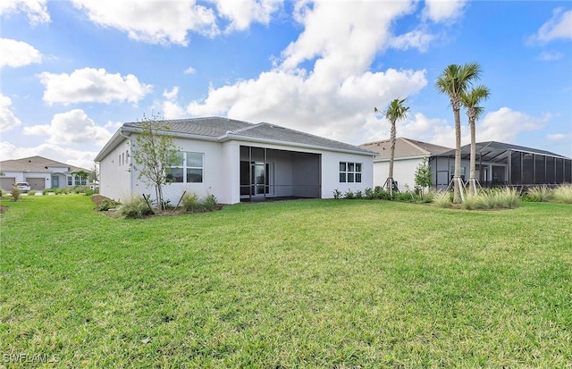 rear view of house featuring a lawn