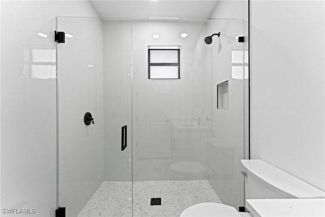 bathroom featuring toilet and an enclosed shower