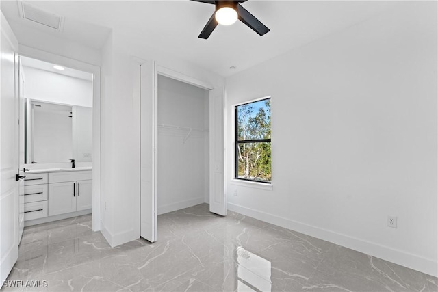 unfurnished bedroom with a closet, ceiling fan, and sink