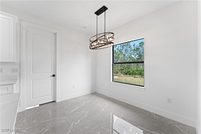 unfurnished dining area with a chandelier