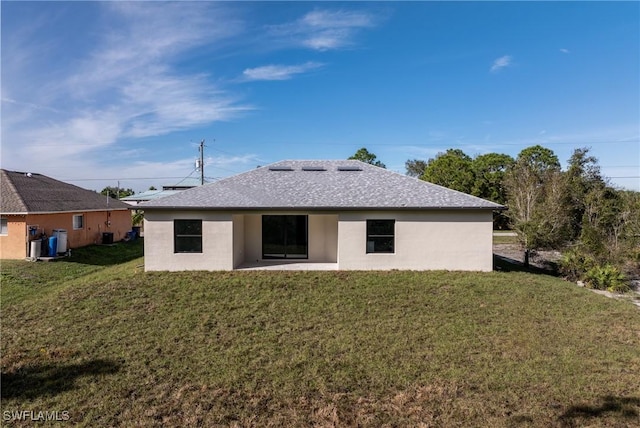 back of property featuring a patio area and a yard