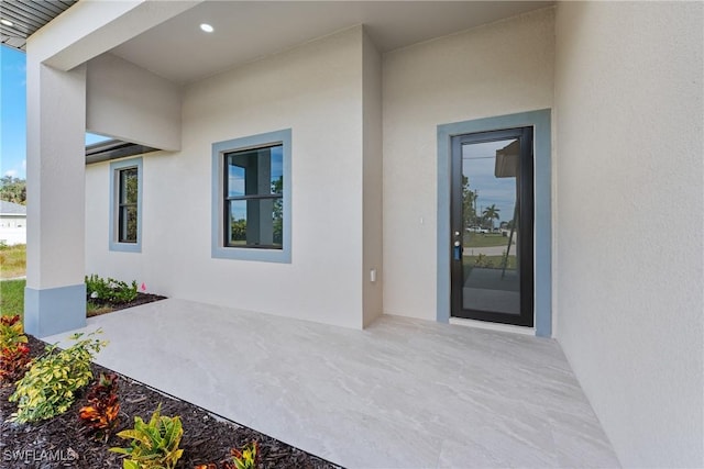 entrance to property featuring a patio area