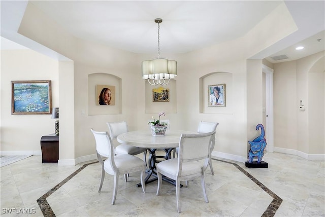 dining space with a chandelier