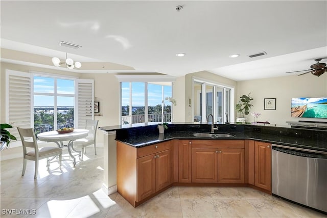 kitchen featuring dishwasher, a healthy amount of sunlight, dark stone countertops, and sink