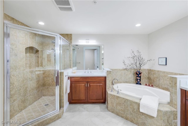 bathroom featuring vanity and shower with separate bathtub