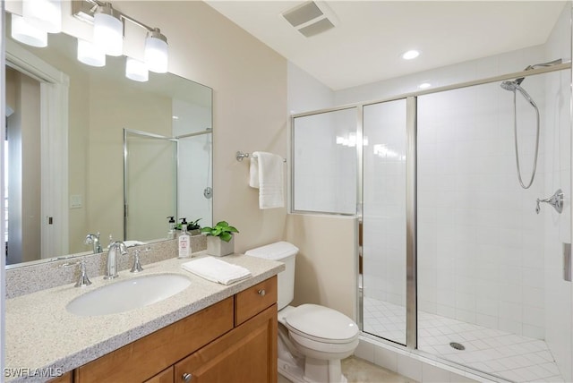 bathroom featuring an enclosed shower, vanity, and toilet