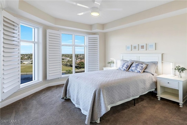 bedroom featuring dark colored carpet and ceiling fan