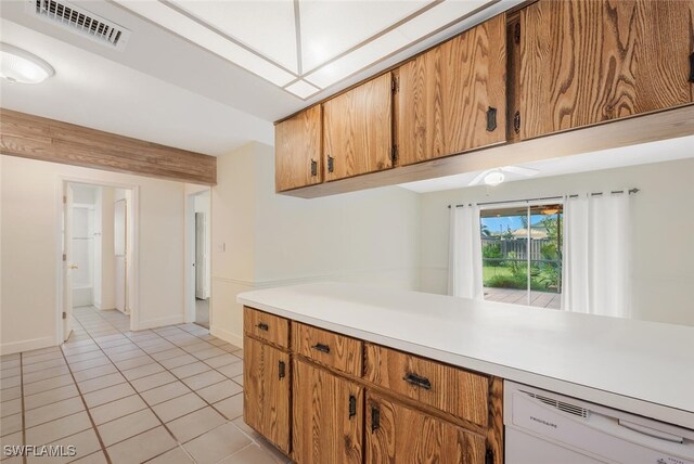 kitchen with white dishwasher and light tile patterned flooring