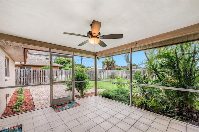 unfurnished sunroom featuring ceiling fan