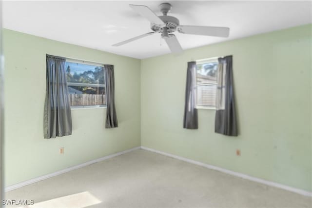 unfurnished room featuring ceiling fan and light carpet