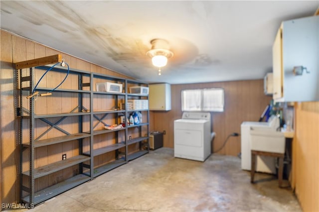 basement with wood walls and sink