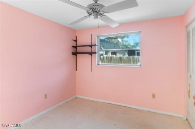 unfurnished room featuring ceiling fan and light carpet