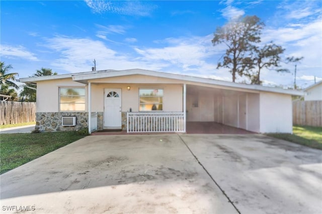 ranch-style home with covered porch and a front yard