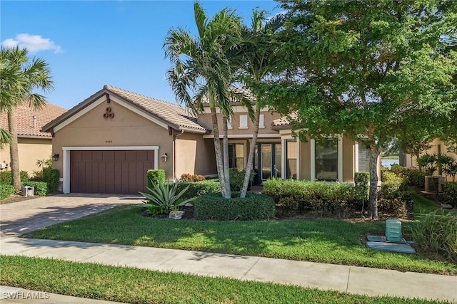 view of front of home with a front lawn and a garage