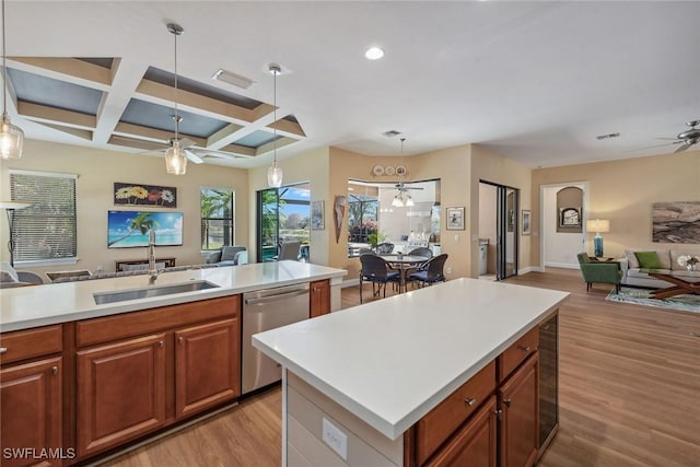 kitchen with a center island, coffered ceiling, light hardwood / wood-style flooring, stainless steel dishwasher, and beam ceiling