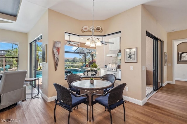 dining space with a notable chandelier and hardwood / wood-style flooring