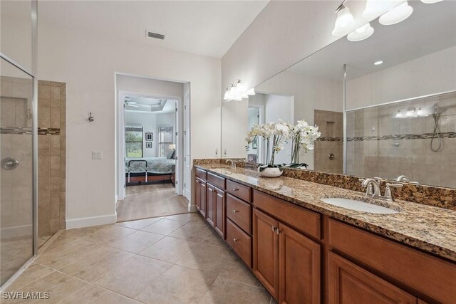 bathroom with tile patterned floors, vanity, ceiling fan, and a shower with shower door