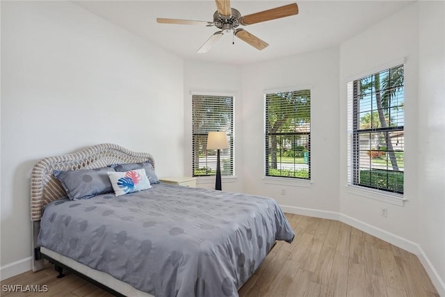 bedroom with ceiling fan and light wood-type flooring