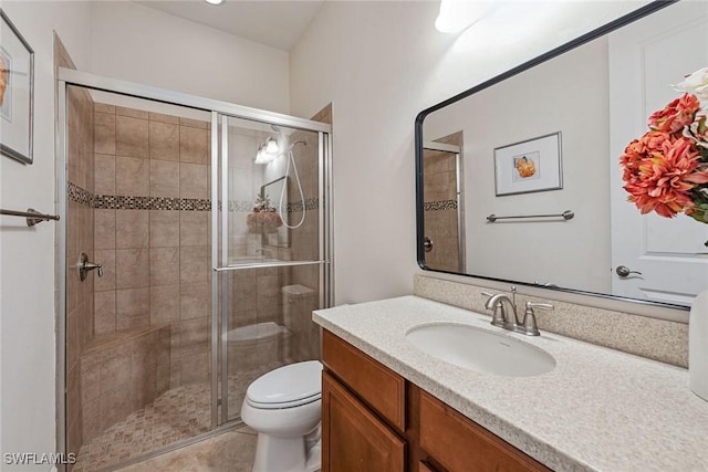 bathroom featuring walk in shower, tile patterned flooring, vanity, and toilet