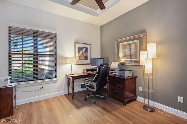 home office featuring ceiling fan, ornamental molding, and light hardwood / wood-style flooring