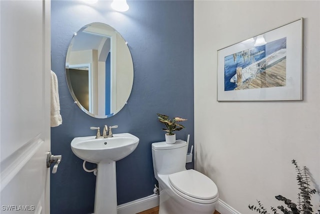 8464 Palacio Ter W, Naples, FL 34114 - half bathroom with toilet, baseboards, and a sink