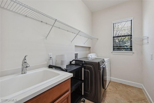 8464 Palacio Ter W, Naples, FL 34114 - laundry room with washer and clothes dryer, baseboards, light tile patterned floors, and cabinet space