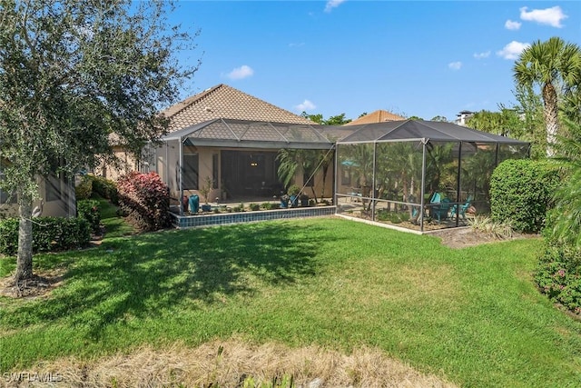 8464 Palacio Ter W, Naples, FL 34114 - rear view of property with a tiled roof, a lawn, and glass enclosure