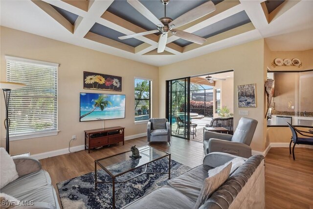 8464 Palacio Ter W, Naples, FL 34114 - living room with coffered ceiling, ceiling fan, baseboards, wood finished floors, and beam ceiling