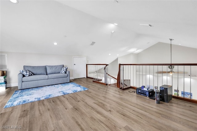 sitting room featuring lofted ceiling and light hardwood / wood-style flooring