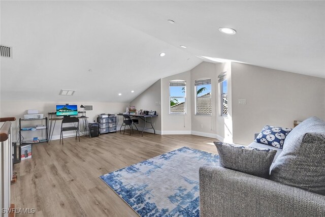 interior space with light hardwood / wood-style floors and vaulted ceiling