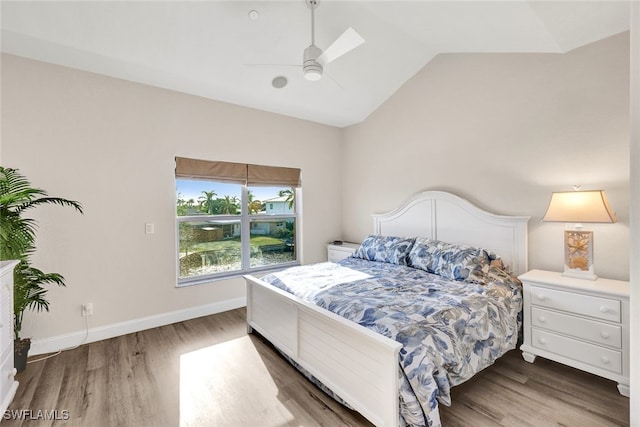 bedroom with ceiling fan, lofted ceiling, and hardwood / wood-style flooring