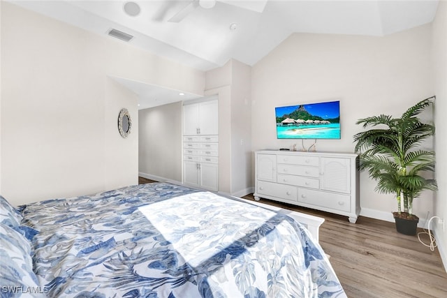 bedroom featuring ceiling fan, lofted ceiling, and light hardwood / wood-style flooring